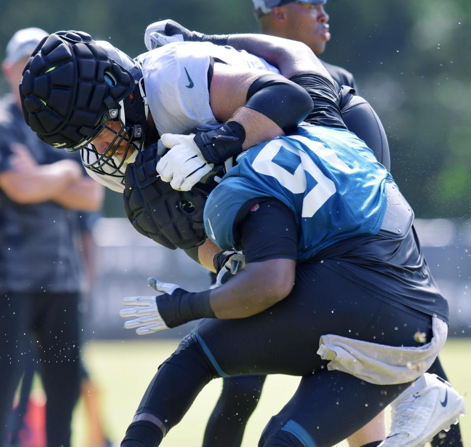 Jacksonville Jaguars offensive lineman Tyler Shatley (69) tries to stop defensive lineman Dawuane Smoot (91)during one-on-one drills at Monday's training camp. The Jacksonville Jaguars held training camp Monday, August 1, 2022, at the Episcopal School of Jacksonville Knight Campus practice fields on Atlantic Blvd.