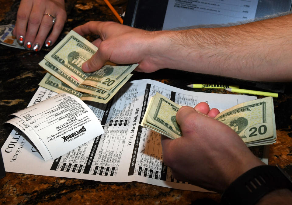 Jake Sindberg of Wisconsin makes bets during a viewing party for the NCAA Men's College Basketball Tournament on March 15, 2018 in Las Vegas.  (Photo by Ethan Miller/Getty Images)