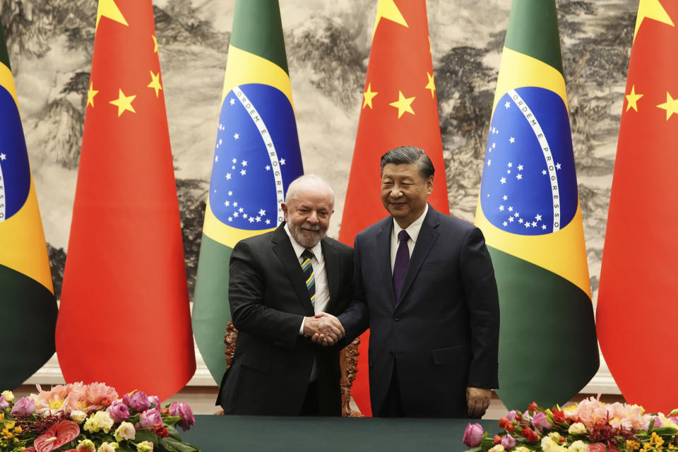 Brazilian President Luiz Inacio Lula da Silva, left, shakes hands with Chinese President Xi Jinping after a signing ceremony held at the Great Hall of the People in Beijing, China, Friday, April 14, 2023. (Ken Ishii/Pool Photo via AP)