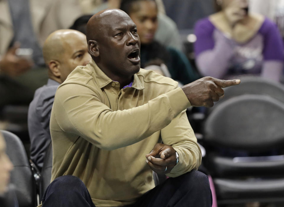 Charlotte Hornets owner Michael Jordan shouts to his team during the first half of an NBA basketball game against the Utah Jazz in Charlotte, N.C., Friday, Jan. 12, 2018. (AP Photo/Chuck Burton)