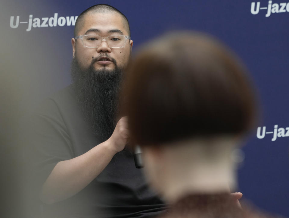 Chinese dissident artist Badiucao speaks at a news conference ahead of the opening of a new exhibition in Warsaw, Poland on Friday, June 16, 2023. The museum faced demands from the Chinese embassy not to open the exhibition, which is highly critical of China's human rights record. (AP Photo/Czarek Sokolowski)