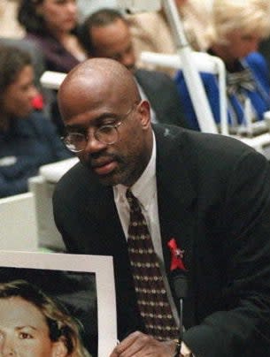 Christopher in court in a suit and thin glasses