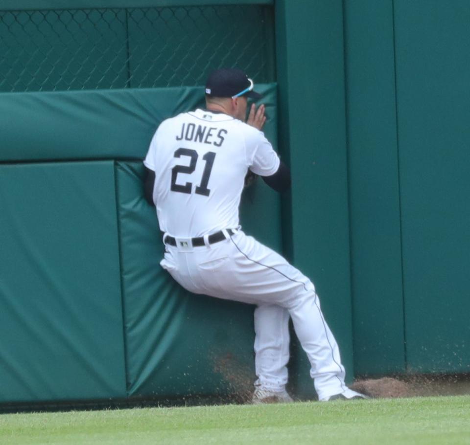 Detroit Tigers outfielder JaCoby Jones catches a fly ball and crashes into the fence vs. the Pittsburgh Pirates on Thursday, April 22, 2021 at Comerica Park.