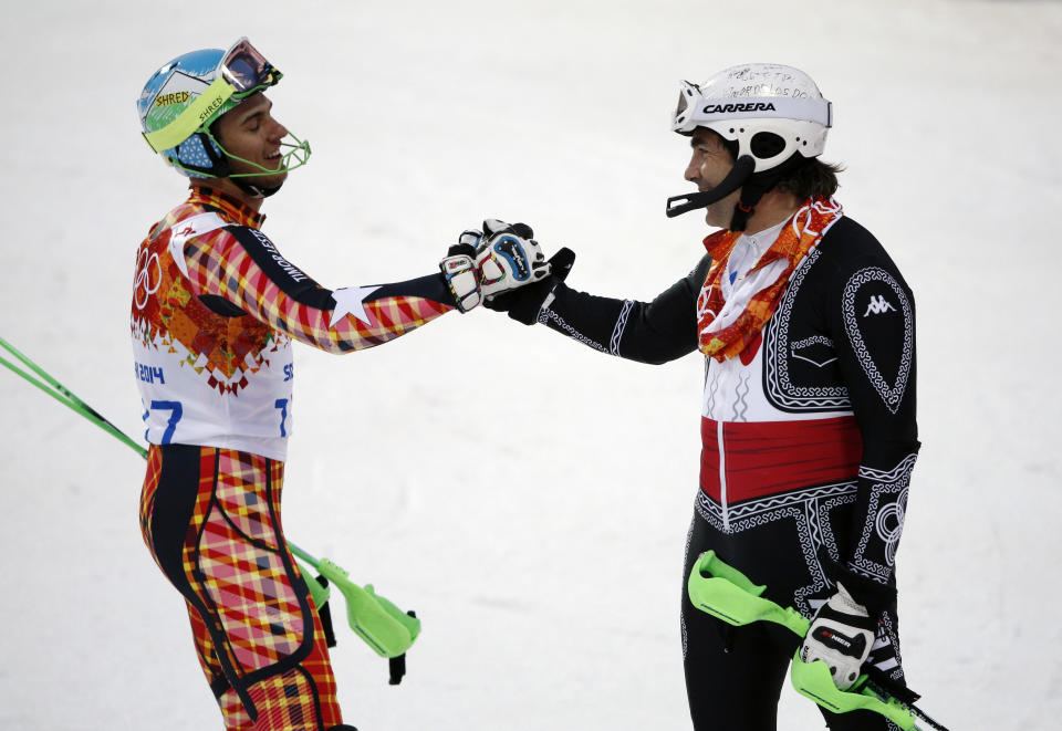 Mexico's Hubertus von Hohenlohe, right, and East Timor's Yohan Goncalves Goutt shake hands after von Hohenlohe crashed during first run of the men's slalom at the Sochi 2014 Winter Olympics, Saturday, Feb. 22, 2014, in Krasnaya Polyana, Russia. (AP Photo/Christophe Ena)