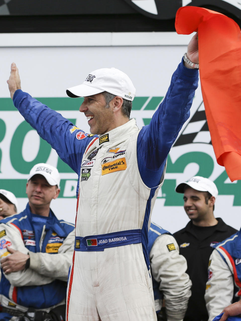 Joao Barbosa, of Portugal, celebrates in Victory Lane with the Action Express Corvette DP team after winning the IMSA Series Rolex 24 hour auto race at Daytona International Speedway in Daytona Beach, Fla., Sunday, Jan. 26, 2014.(AP Photo/John Raoux)