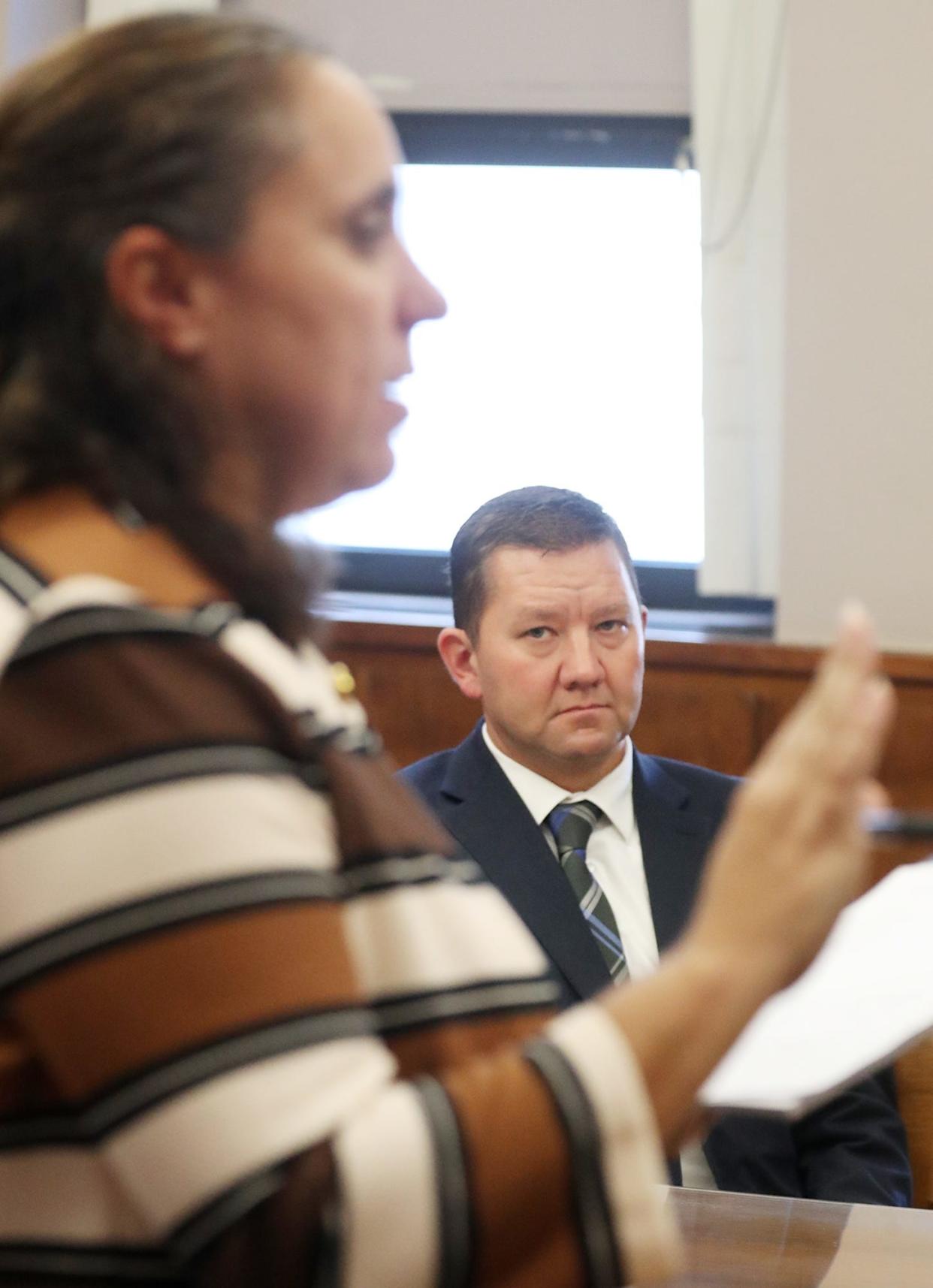 Assistant city prosecutor Jennifer Roberts gives her opening statement as former state Rep. Bob Young listens during his bench trial in Barberton Municipal Court on Tuesday.
