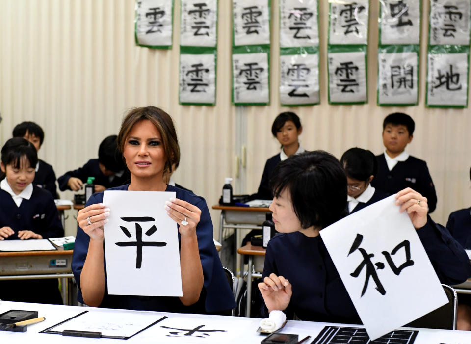 First Lady Melania Trump shows her calligraphy with Akie Abe, wife of Japanese prime minister, while attending a calligraphy class of 4th graders at the Kyobashi Tsukiji elementary school in Tokyo.