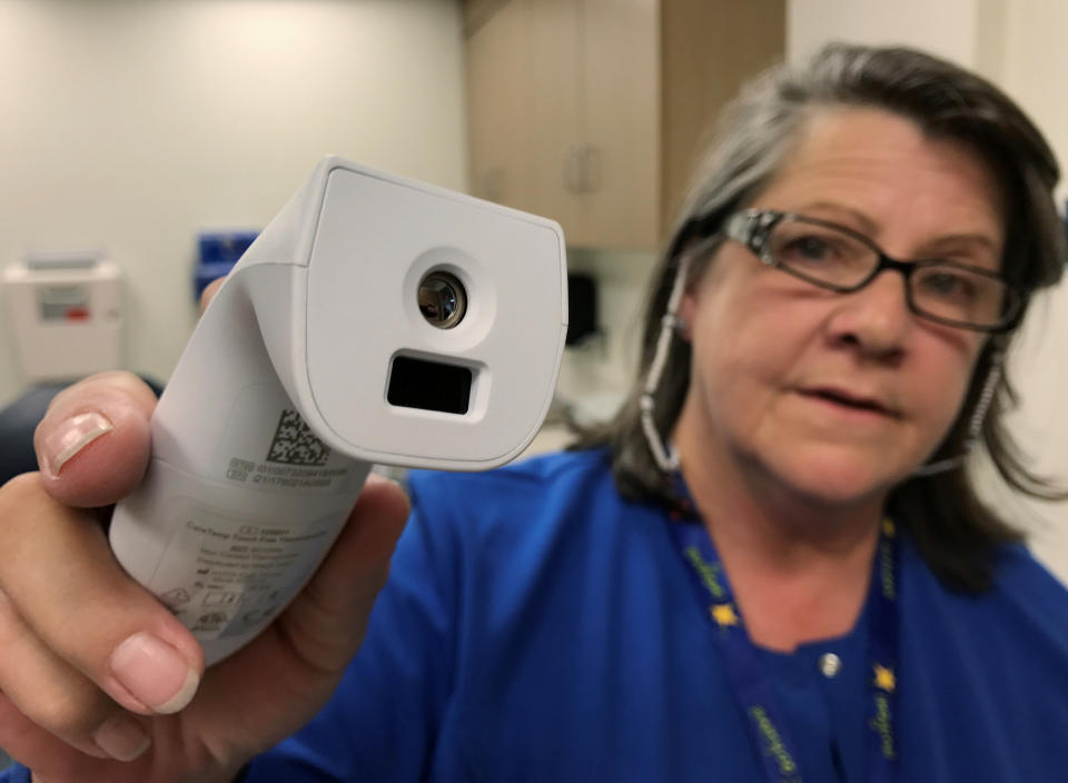 Registered nurse Tara McCormick, Clinical Services Manager, demonstrates an infrared thermometer at West Virginia University Hospital, September 6, 2017. (REUTERS/Mike Wood)