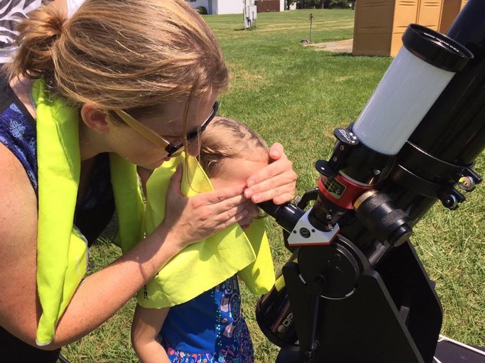 Caitlin Darling of Springfield helps her daughter, Vivien, then 5, look into a special solar telescope during the total solar eclipse on August 21, 2017, in Ava, Illinois. Darling and her family are returning to southern Illinois for Monday's total eclipse.