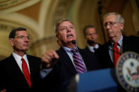 Sen. Lindsey Graham (R-SC), accompanied by Sen. John Barrasso (R-WY), and Senate Majority Leader Mitch McConnell, speaks with reporters following the party luncheons on Capitol Hill in Washington, U.S., September 19, 2017. REUTERS/Aaron P. Bernstein