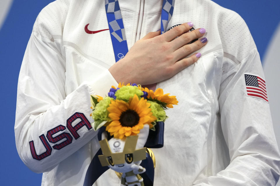 Gold medalist Lydia Jacoby of the United States stands on the podium after receiving her gold medal in the final of the women's 100-meter breaststroke at the 2020 Summer Olympics, Tuesday, July 27, 2021, in Tokyo, Japan. (AP Photo/Matthias Schrader)