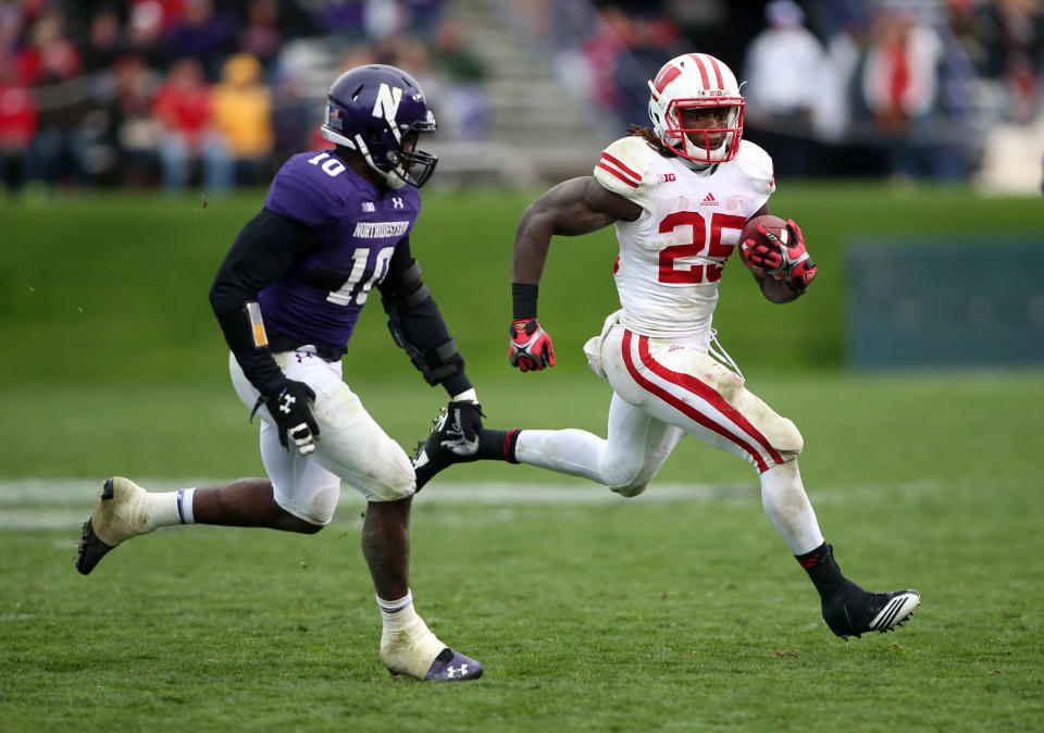 Oct. 4, 2014; Evanston, Illinois; Wisconsin Badgers running back Melvin Gordon (25) runs past Northwestern Wildcats safety Traveon Henry (10) during the second half at Ryan Field. Jerry Lai-USA TODAY Sports