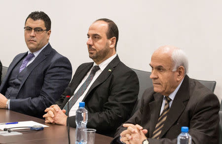 Naser al-Hariri (C), Head of the Syrian Negotiation Commission (SNC), attends a round of negotiations with United Nations Special Envoy of the Secretary-General for Syria Staffan de Mistura (not pictured), during the Intra Syria talks, at the European headquarters of the U.N. in Geneva, Switzerland December 14, 2017. REUTERS/Xu Jinquan/Pool