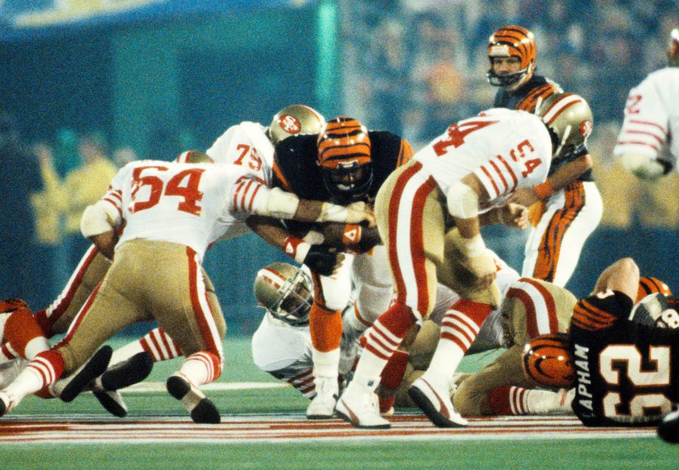 Jan 24, 1982; Pontiac, MI, USA; FILE PHOTO; Cincinnati Bengals running back Pete Johnson (46) caries the ball against San Francisco 49ers defenders Jack Reynolds (64), Jim Stuckey (79) and Craig Puki (54) during Super Bowl XVI at the Pontiac Superdome. The 49ers defeated the Bengals 26-21. Mandatory Credit: Manny Rubio-USA TODAY Sports