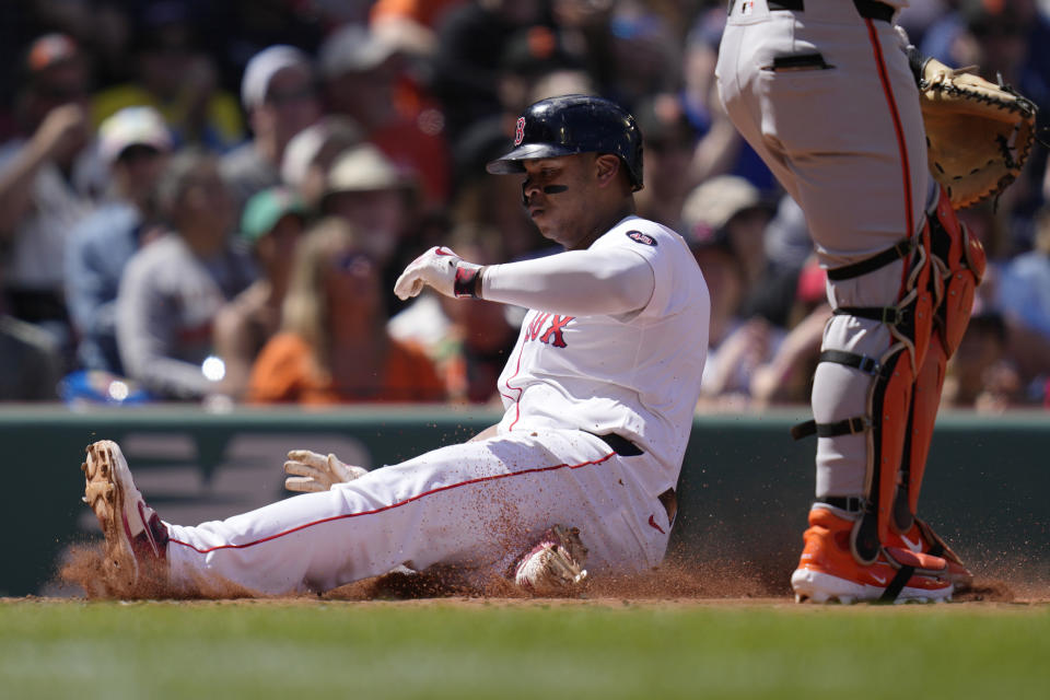 Boston Red Sox's Rafael Devers scores on a double by Tyler O'Neill during the third inning of a baseball game against the San Francisco Giants at Fenway Park, Thursday, May 2, 2024, in Boston. (AP Photo/Charles Krupa)