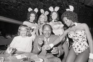 Mayor Thomas Bradley of Los Angeles is shown autographing the cuff of Bunny Gloria at the gala opening of the Playboy Club August 23.