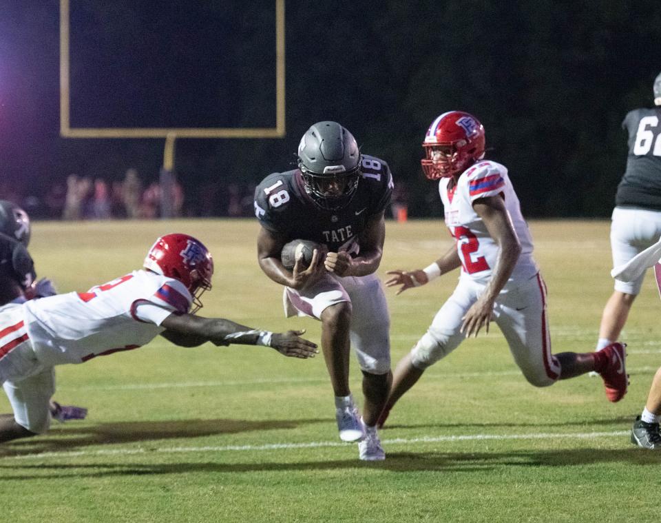 Andre Colston (18) takes it in for a touchdown cutting the Eagles lead to 13-6 during the Pine Forest vs Tate football game at Tate High School in Cantonment on Friday, Aug. 25, 2023.