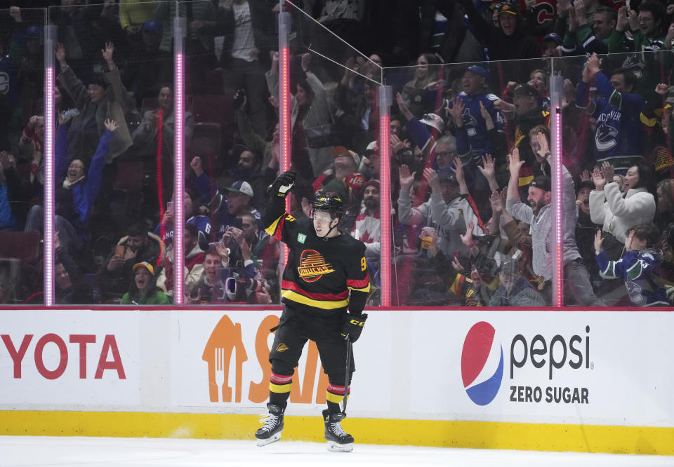 Vancouver Canucks' Andrei Kuzmenko celebrates his shootout goal against Calgary Flames goalie Jacob Markstrom during an NHL hockey game Saturday, April 8, 2023, in Vancouver, British Columbia. (Darryl Dyck/The Canadian Press via AP)