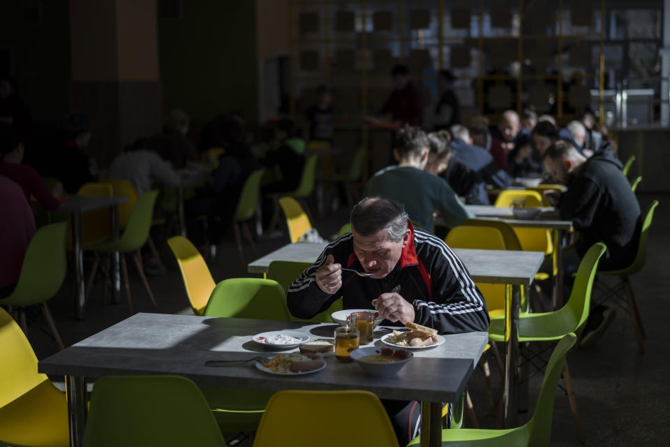 Internally displaced people have lunch at school canteen in Lviv, western Ukraine, Monday, March 14, 2022. (AP Photo/Bernat Armangue)