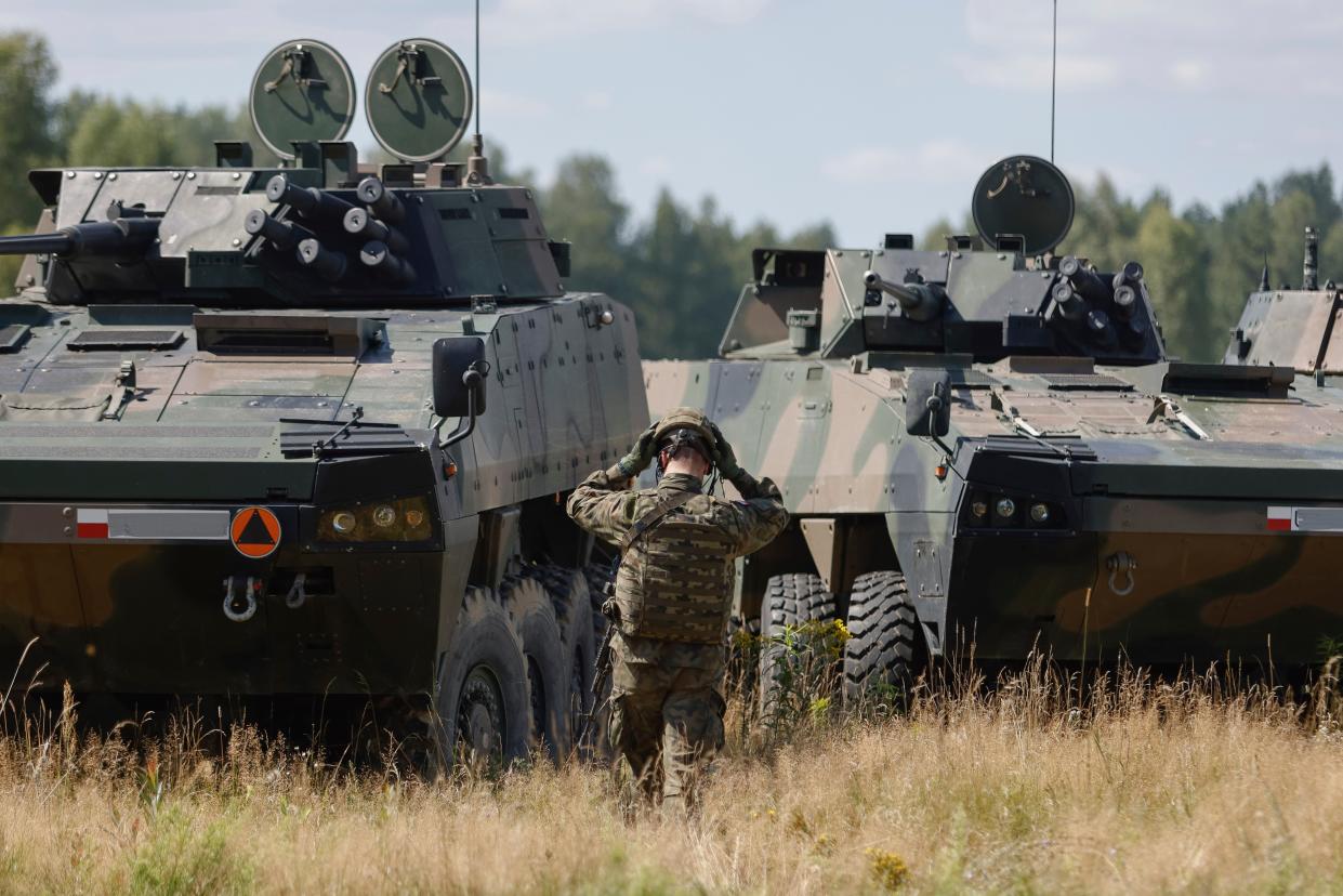 Polish serviceman puts a helmet on prior to a press conference of Poland’s Minister of Defence (AP)