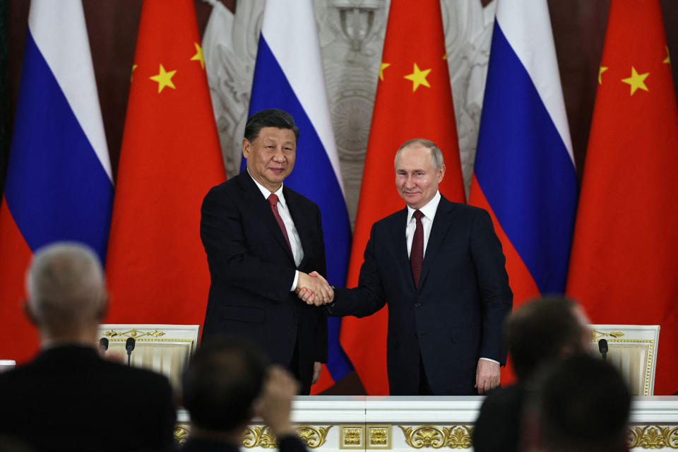 Russian President Vladimir Putin and China’s President Xi Jinping shake hands after delivering a joint statement following their talks at the Kremlin in Moscow (Mikhail Tereshchenko / SPUTNIK/AFP via Getty Images file )