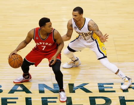 Apr 29, 2016; Indianapolis, IN, USA; Toronto Raptors guard Kyle Lowry (7) dribbles the ball as Indiana Pacers guard George Hill (3) defends during the first quarter in game six of the first round of the 2016 NBA Playoffs at Bankers Life Fieldhouse. Mandatory Credit: Brian Spurlock-USA TODAY Sports