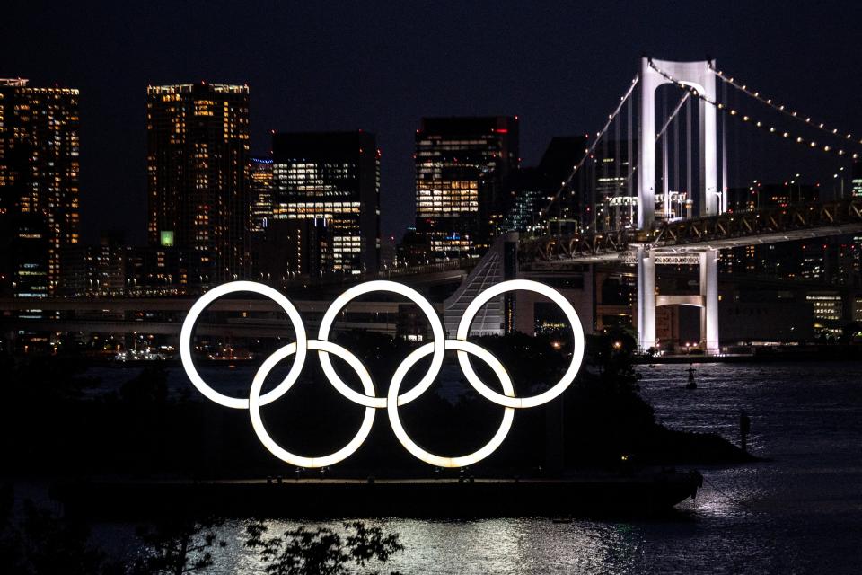 A general view shows the Olympic rings lit up at dusk on the Odaiba waterfront in Tokyo on May 31, 2021. (Photo by Charly TRIBALLEAU / AFP) (Photo by CHARLY TRIBALLEAU/AFP via Getty Images)