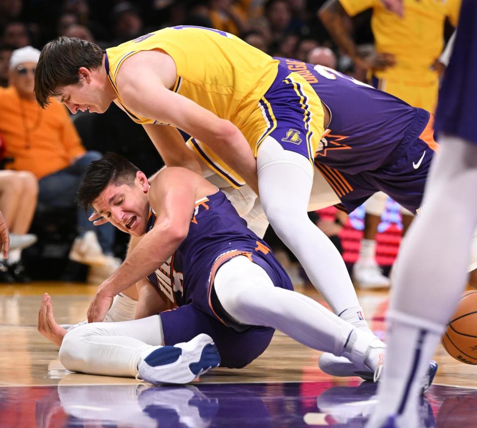 Lakers guard Austin Reaves and Suns guard Grayson Allen battle for loose ball in the second quarter Thursday.