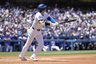 Los Angeles Dodgers designated hitter Shohei Ohtani reacts after hitting a home run during the first inning of a baseball game against the Atlanta Braves in Los Angeles, Sunday, May 5, 2024. Mookie Betts also scored. (AP Photo/Ashley Landis)