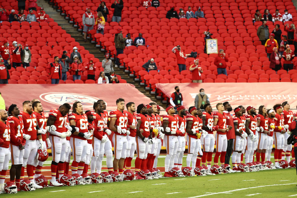 Members of the Kansas City Chiefs stand united for with locked arms.