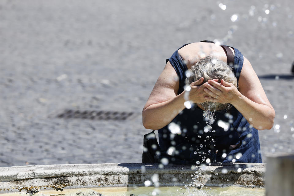 A woman cools off at a fountain in downtown Rome, Thursday, July 11, 2024. (Cecilia Fabiano/LaPresse via AP)