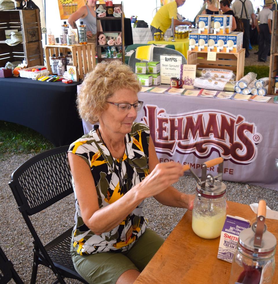 Charlene Price of Lehman's demonstrates how to churn butter with with a Kilner Butter Churner at the Independent Food Summit, Seed to Spoon, celebration in Walnut Creek on Thursday.
