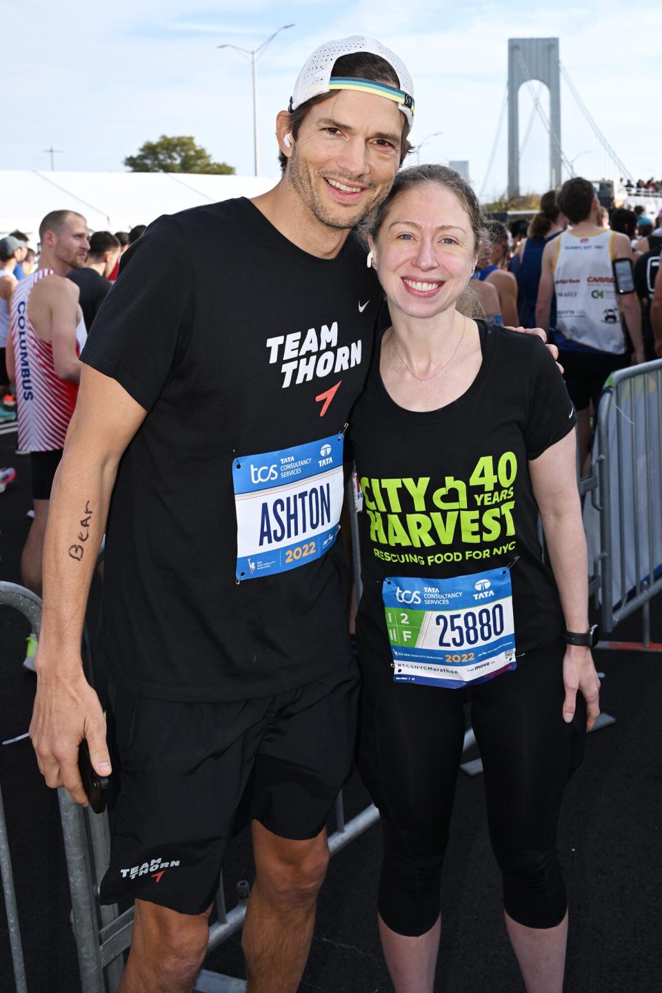 Ashton Kutcher and Chelsea Clinton run during the 2022 TCS New York City Marathon on November 06, 2022 in New York City.