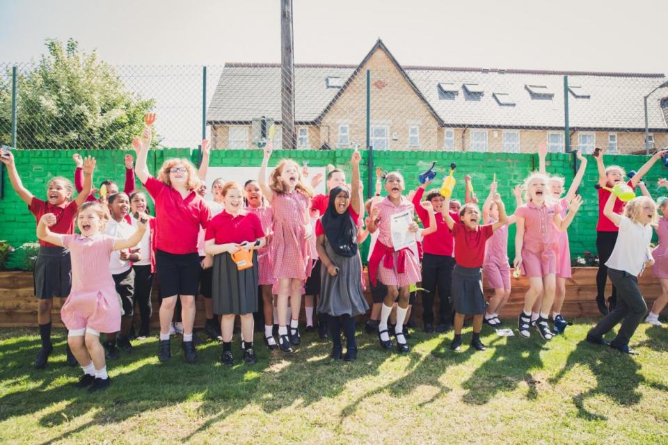 Amaia and her classmates celebrate the unvieling of the new garden