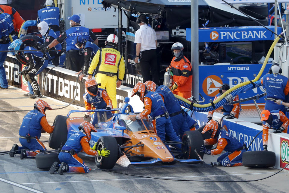 Scott Dixon has a change of tires and adjustments made to his car during a pit stop early during an IndyCar auto race at Texas Motor Speedway in Fort Worth, Texas, Saturday, June 6, 2020. (AP Photo/Tony Gutierrez)