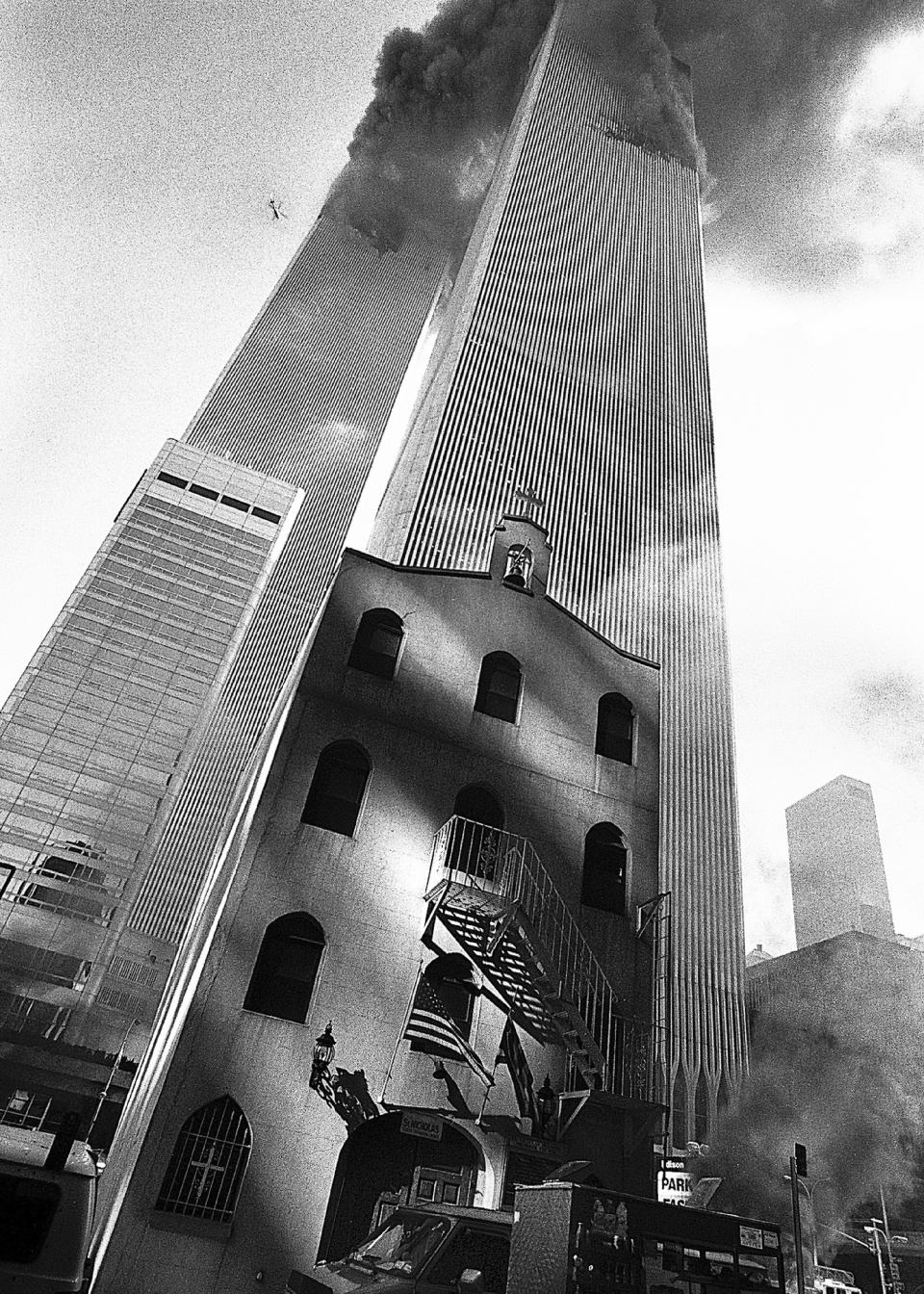 In this Sept. 11, 2001, photo provided by the Greek Orthodox Archdiocese of America, smoke billows from the World Trade Center towers as St. Nicholas Greek Orthodox Church sits below them in New York's financial district. St. Nicholas was the only house of worship destroyed in the Sept. 11, 2001 attacks. (Greek Orthodox Archdiocese of America via AP)