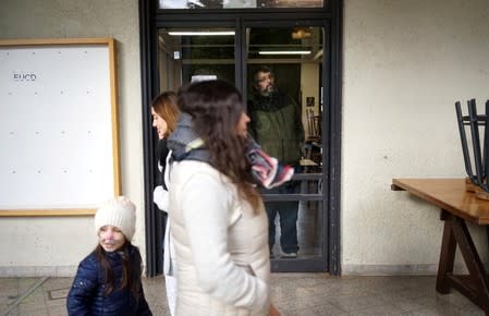 A man looks out of the window of a polling station during primary elections ahead of the presidential elections later this year, in Montevideo