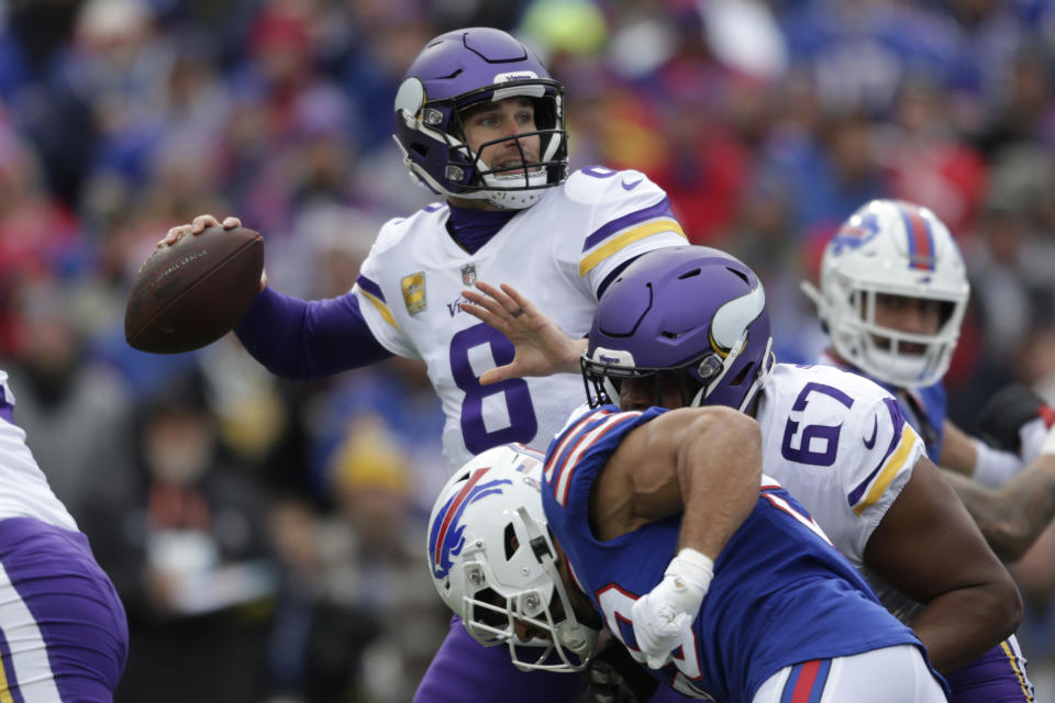 Minnesota Vikings quarterback Kirk Cousins (8) looks to pass while under pressure from Buffalo Bills linebacker Matt Milano, below center, in the first half of an NFL football game, Sunday, Nov. 13, 2022, in Orchard Park, N.Y. (AP Photo/Joshua Bessex)