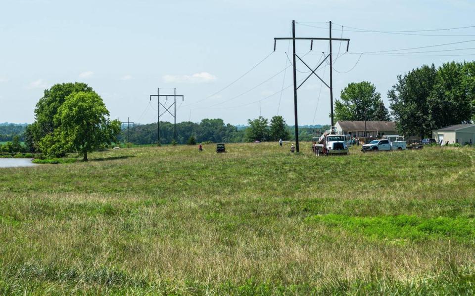 Crews with the NW Electric Power Collective asses damaged power lines that were downed during a fatal plane crash on Thursday, July 20, 2023, in Kearney. The plane crashed in a field near NE 150th Street and Cordell Road shortly after taking off from Midwest Regional Air Center. Zachary Linhares/zlinhares@kcstar.com