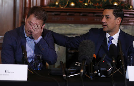 Former footballer Andy Woodward (R) consoles colleague Steve Walters at the launch of The Offside Trust, an independent group set up to support players and their families who have suffered abuse, in Manchester northern England. REUTERS/Phil Noble