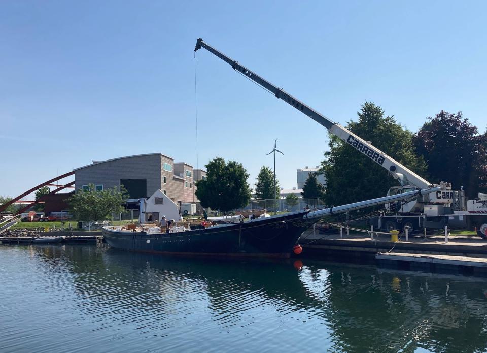 Workers prepare to install a newly-repaired mainmast on the Lettie G. Howard, shown here behind the Erie Maritime Museum on July 5, 2023.