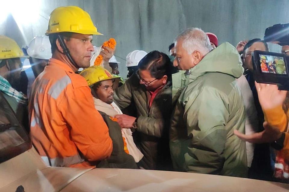 <p>UTTARAKAHAND INFORMATION DEPARTMENT/HANDOUT/EPA-EFE/Shutterstock </p> A handout photo from the Uttrakahand Information Department shows Uttarakhand Chief Minister Pushkar Singh Dhami (C) and Union Minister VK Singh (R) garland the first rescued worker inside the tunnel on the Brahmakal Yamunotri National Highway in Uttarkashi, India, on November, 25 2023.