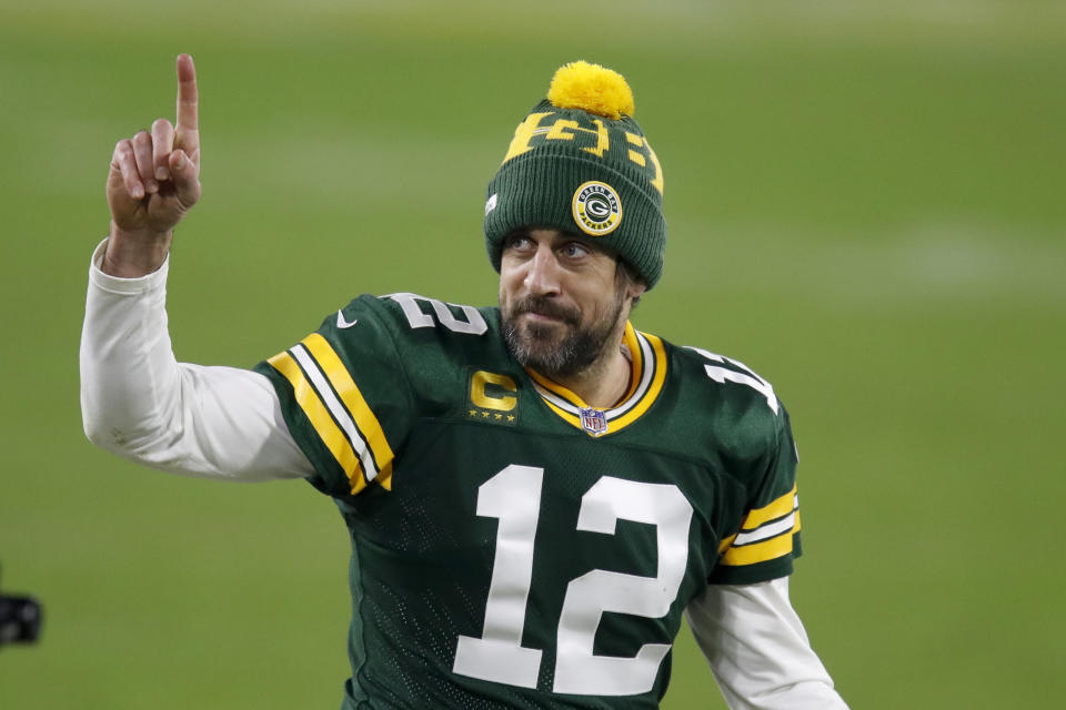 Green Bay Packers quarterback Aaron Rodgers gestures to fans after an NFL divisional playoff football game against the Los Angeles Rams Saturday, Jan. 16, 2021, in Green Bay, Wis. The Packers defeated the Rams 32-18 to advance to the NFC championship game. (AP Photo/Matt Ludtke)