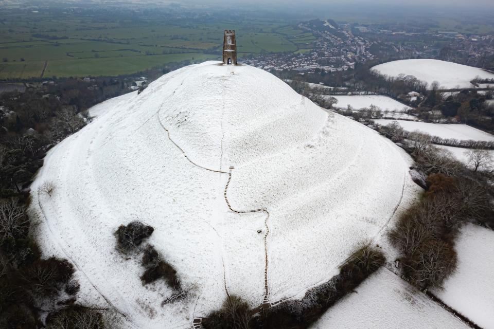 Snow settles on Glastonbury Tor as parts of the UK wake up to snow and a yellow weather warning (Ben Birchall/PA Wire)