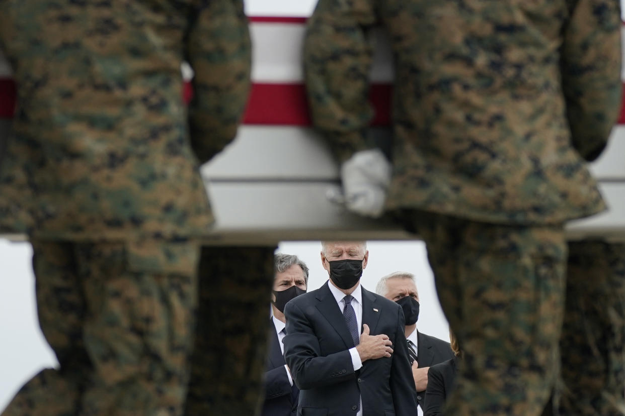 FILE - President Joe Biden watches as a carry team moves a transfer case containing the remains of Marine Corps Lance Cpl. Kareem M. Nikoui, 20, of Norco, Calif., during a casualty return, Aug. 29, 2021, at Dover Air Force Base, Del. According to the Department of Defense, Nikoui died in an attack at Afghanistan's Kabul airport, along with 12 other U.S. service members. The Taliban have killed the senior Islamic State group leader behind the August 2021 bombing outside the Kabul airport that killed 13 service members and about 170 Afghans. That is according to the father of a Marine killed in the attack who was briefed on April 25, 2023, by military officials. (AP Photo/Carolyn Kaster, File)