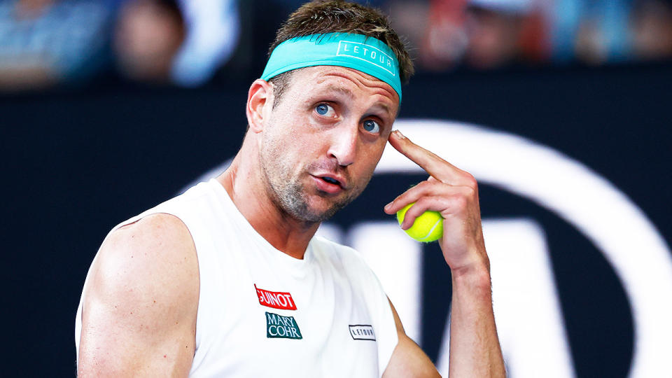 Tennys Sandgren (pictured) pointing to his head in frustration during a match.