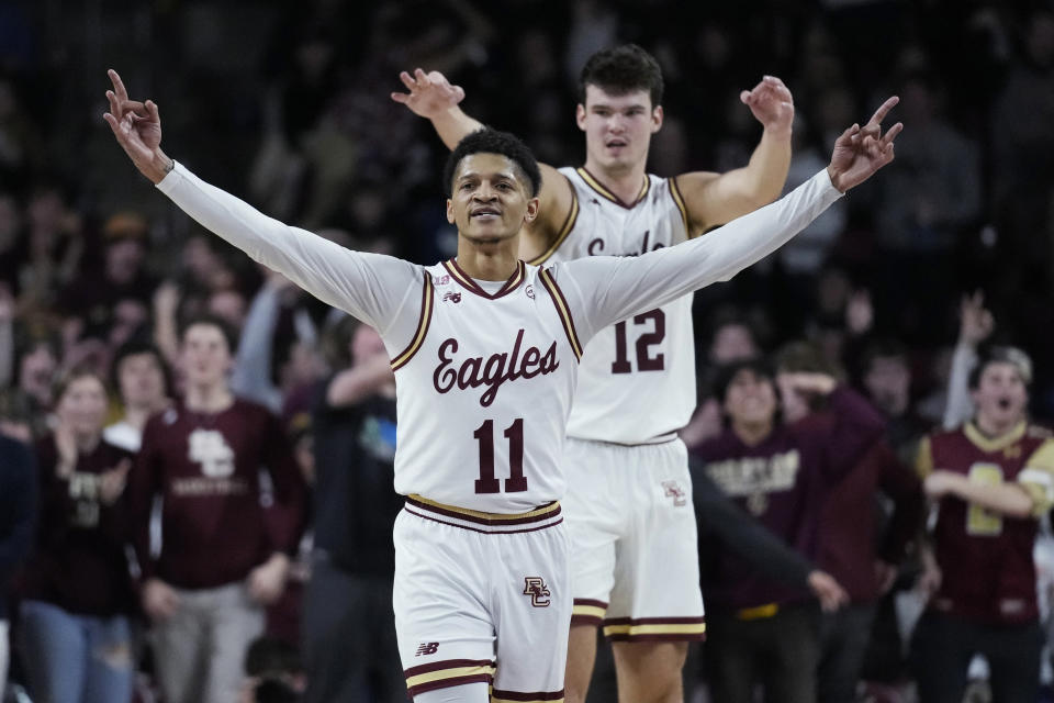 Boston College guard Makai Ashton-Langford (11) and forward Quinten Post (12) celebrate after a 3-pointer by teammate Jaeden Zackery during the second half of an NCAA college basketball game against Virginia, Wednesday, Feb. 22, 2023, in Boston. Boston College upset Virginia 63-48. (AP Photo/Charles Krupa)