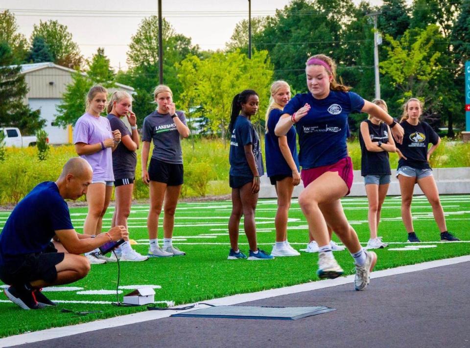 Yoshi Ono (left) works with Libby Cleveland (right) and the Lakeshore United FC youth girls soccer team during a sports performance and injury prevention program.