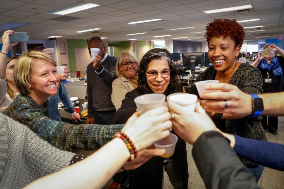 The staff of the Gannett-owned USA TODAY Network's Cincinnati Enquirer celebrate in their newsroom after learning the newspaper won the Pulitzer Prize for local reporting for 