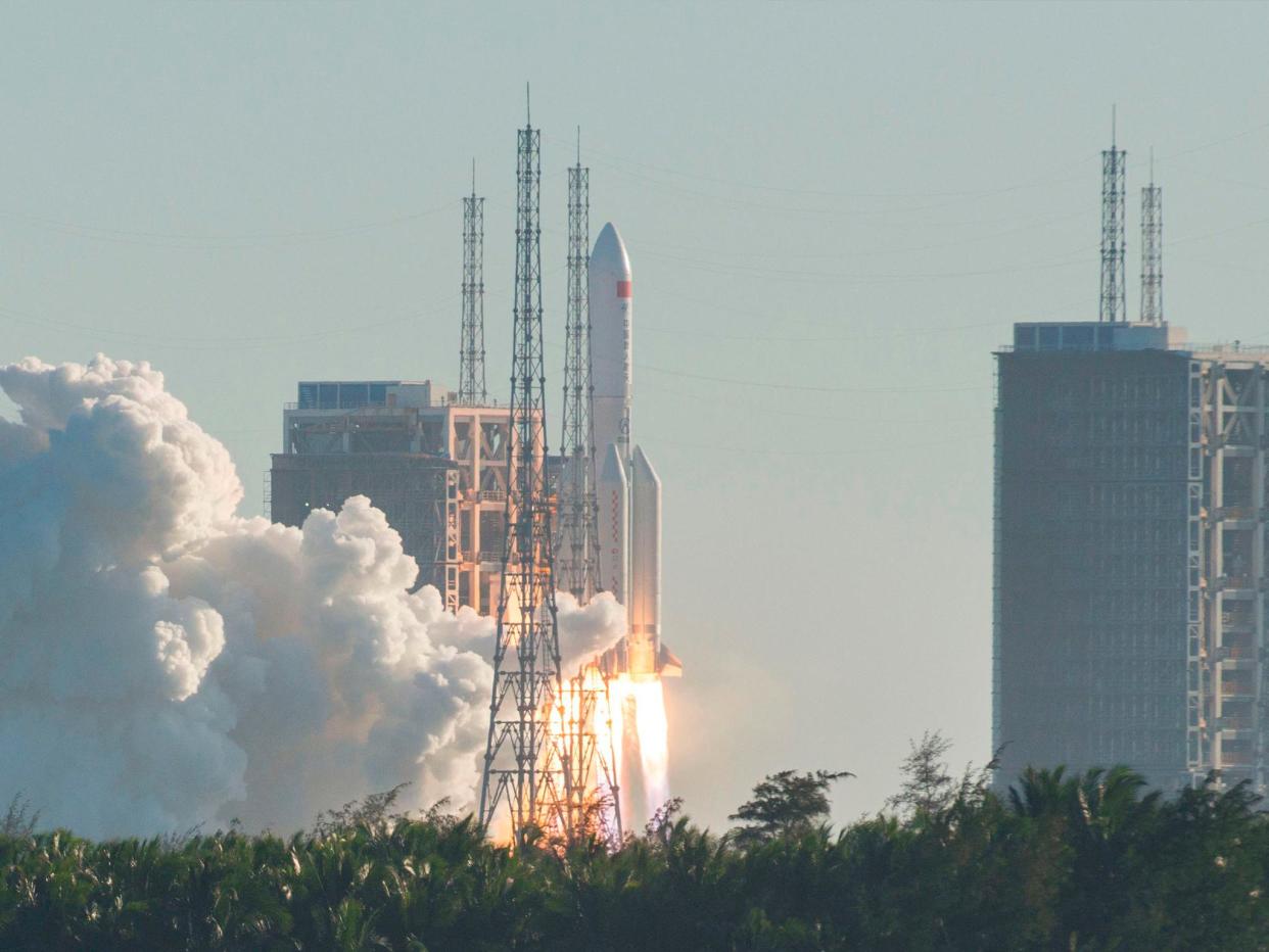 TOPSHOT - A Long March 5B rocket lifts off from the Wenchang launch site on China's southern Hainan island on May 5, 2020. - Chinese state media reported the "successful" launch of a new rocket on May 5, a major test of its ambitions to operate a permanent space station and send astronauts to the Moon. (Photo by STR / AFP) / China OUT (Photo by STR/AFP via Getty Images): Credit: Getty Images